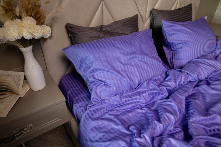 Plush Patagonian Lupine duvet cover draped over a bed, showcasing its silky smooth fabric.